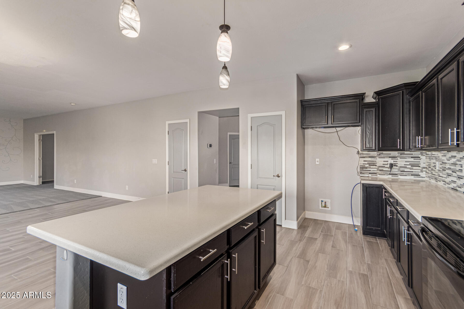 17868 West Charter Oak Road Surprise, AZ 85388 - Photo 22 of 67 a kitchen with kitchen island a stove a sink dishwasher and a refrigerator with wooden floor