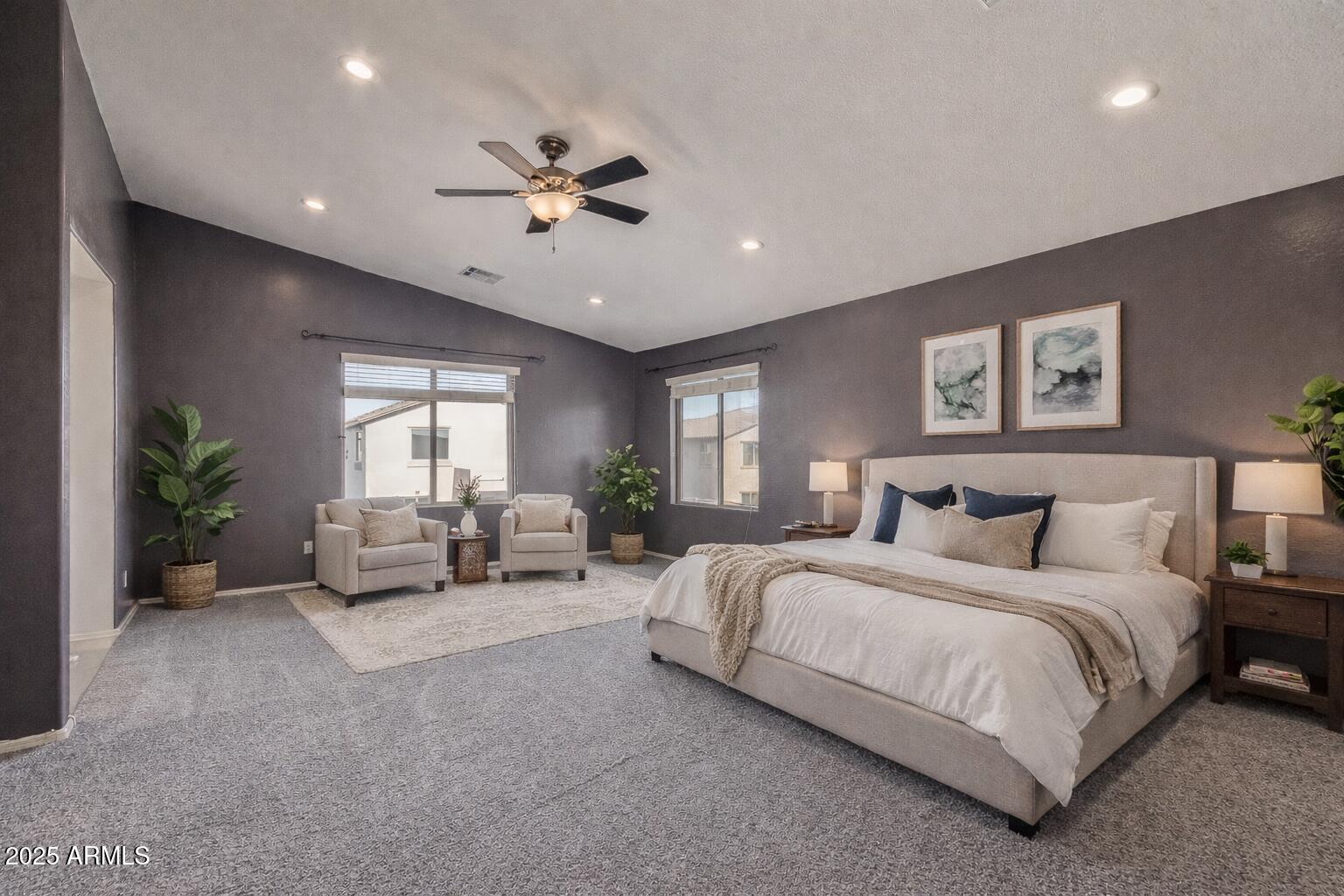 17868 West Charter Oak Road Surprise, AZ 85388 - Photo 27 of 67 a spacious bedroom with a large bed and a chandelier