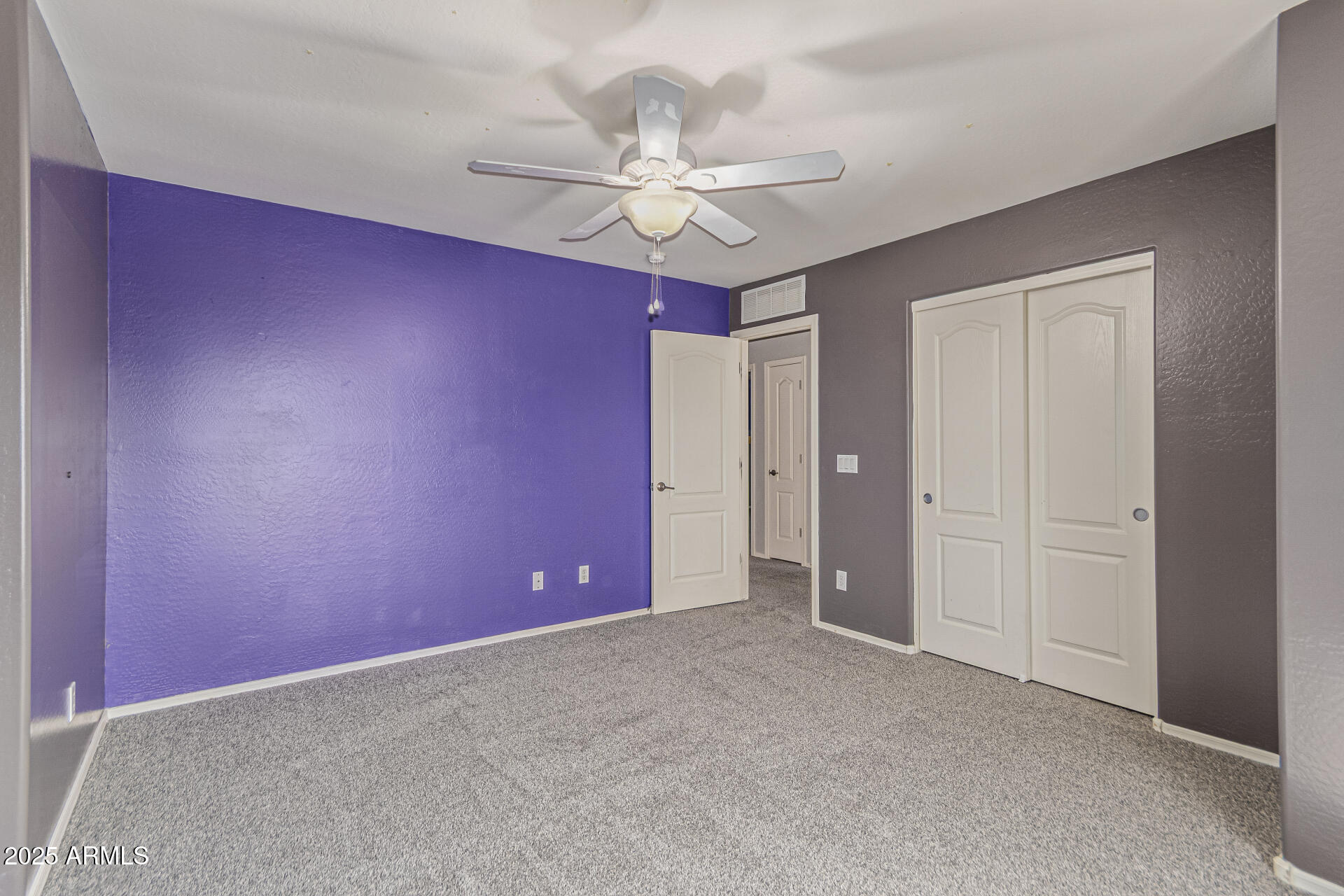 17868 West Charter Oak Road Surprise, AZ 85388 - Photo 35 of 67 an empty room with a ceiling fan and fan