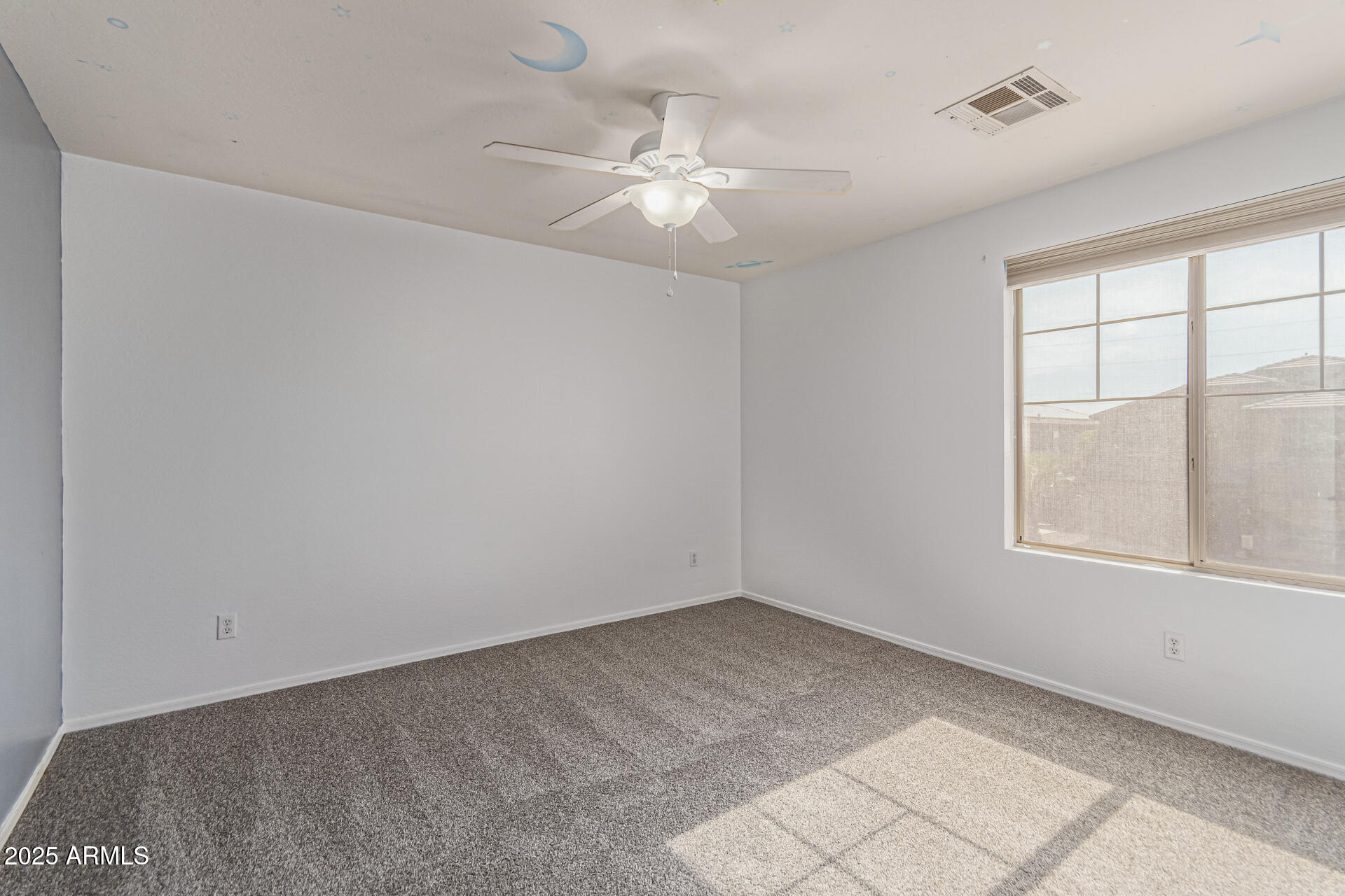 17868 West Charter Oak Road Surprise, AZ 85388 - Photo 42 of 67 an empty room with windows and chandelier fan