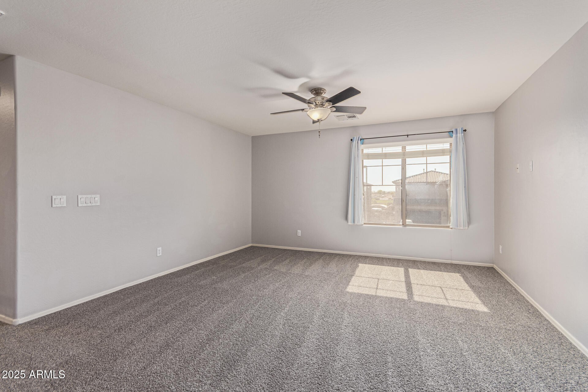17868 West Charter Oak Road Surprise, AZ 85388 - Photo 47 of 67 an empty room with windows and fan