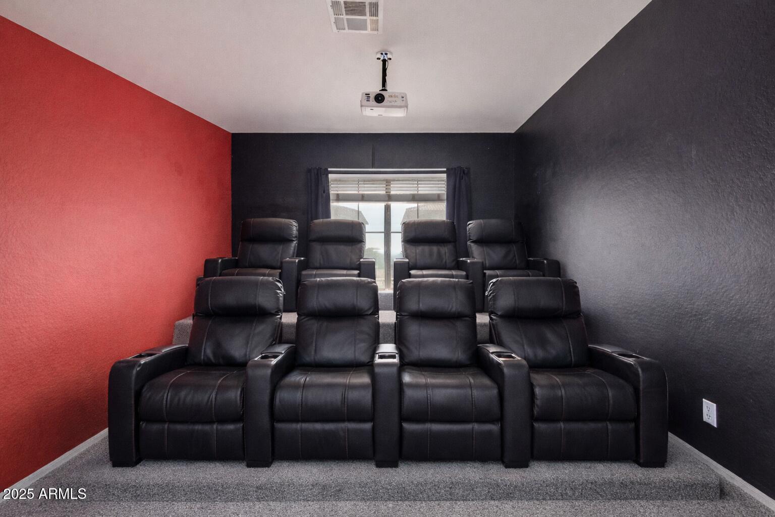 17868 West Charter Oak Road Surprise, AZ 85388 - Photo 51 of 67 a media room with lots of chairs and a projector