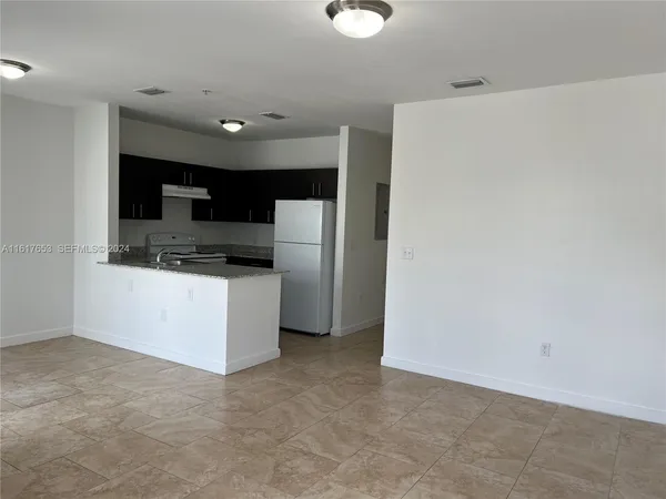 a kitchen with stainless steel appliances a refrigerator and a stove top oven