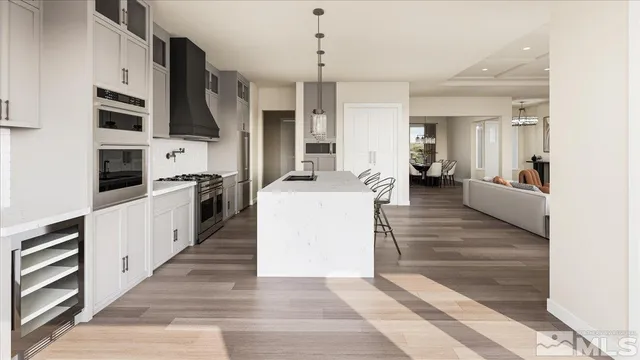 a kitchen with stainless steel appliances kitchen island granite countertop a stove a sink and a refrigerator