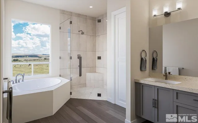 a bathroom with a tub sink and mirror