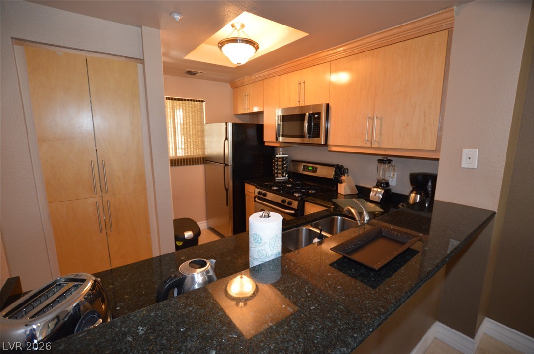 220 East Flamingo Road, Unit 327 Las Vegas, NV 89169 - Photo 9 of 13 A well-appointed culinary space featuring sleek stainless steel appliances and abundant cabinetry.