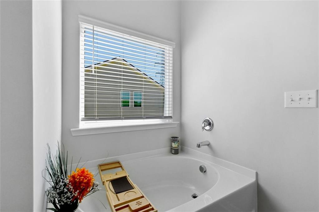 4006 Riverchess Drive Southwest Atlanta, GA 30331 - Photo 19 of 28 a bathroom with a bathtub and a window