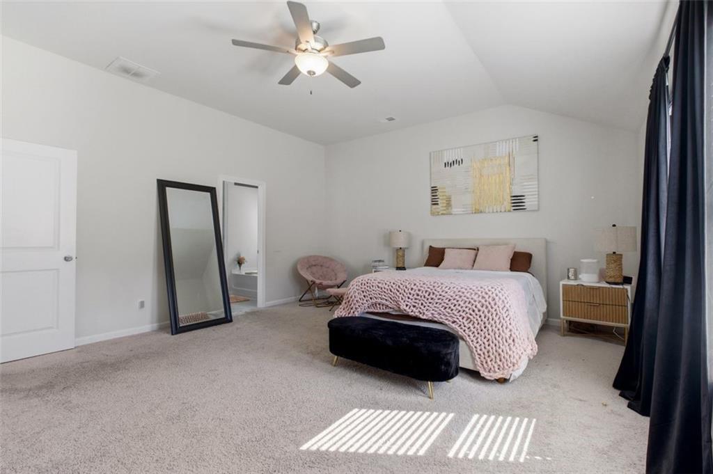 4006 Riverchess Drive Southwest Atlanta, GA 30331 - Photo 23 of 28 a bedroom with a bed and a chandelier