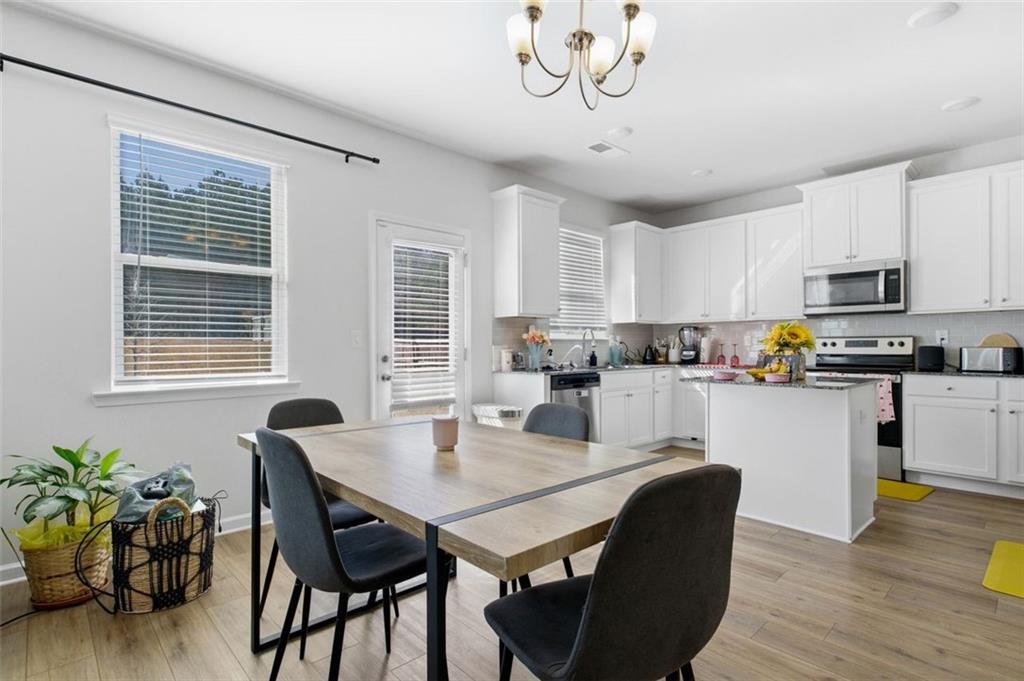 4006 Riverchess Drive Southwest Atlanta, GA 30331 - Photo 8 of 28 a kitchen with a dining table chairs and microwave