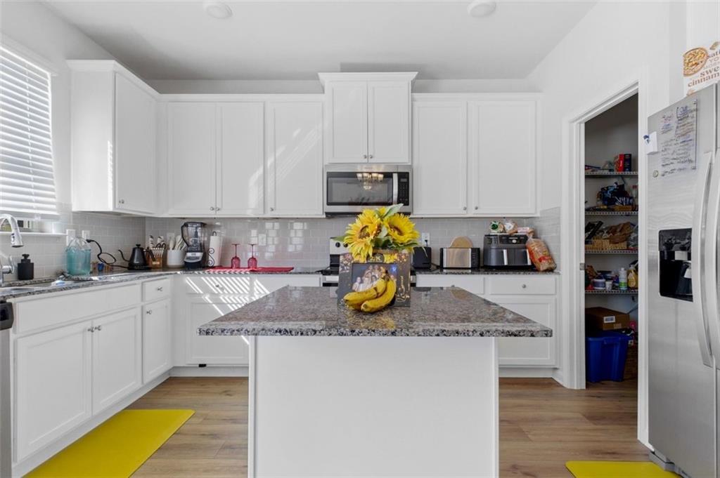 4006 Riverchess Drive Southwest Atlanta, GA 30331 - Photo 10 of 28 a kitchen with a refrigerator a stove a microwave and cabinets