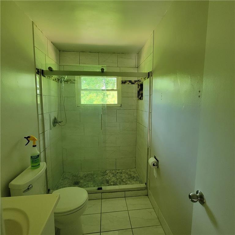 3545 Old Chamblee Tucker Road, Unit C Atlanta, GA 30340 - Photo 13 of 14 a bathroom with a shower and a toilet