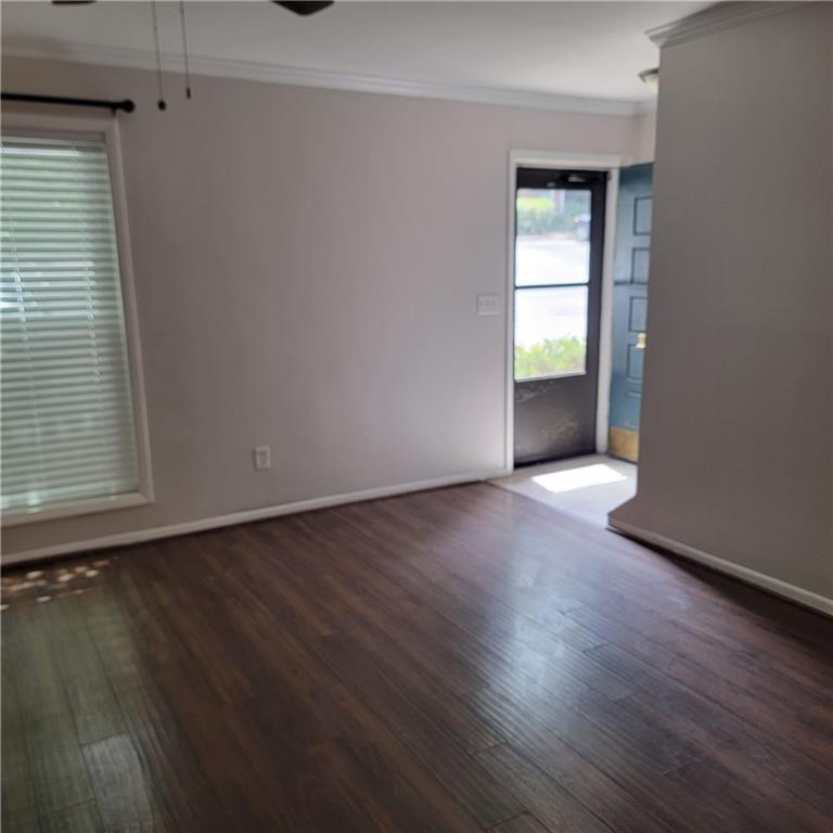 3545 Old Chamblee Tucker Road, Unit C Atlanta, GA 30340 - Photo 2 of 14 an empty room with wooden floor and windows