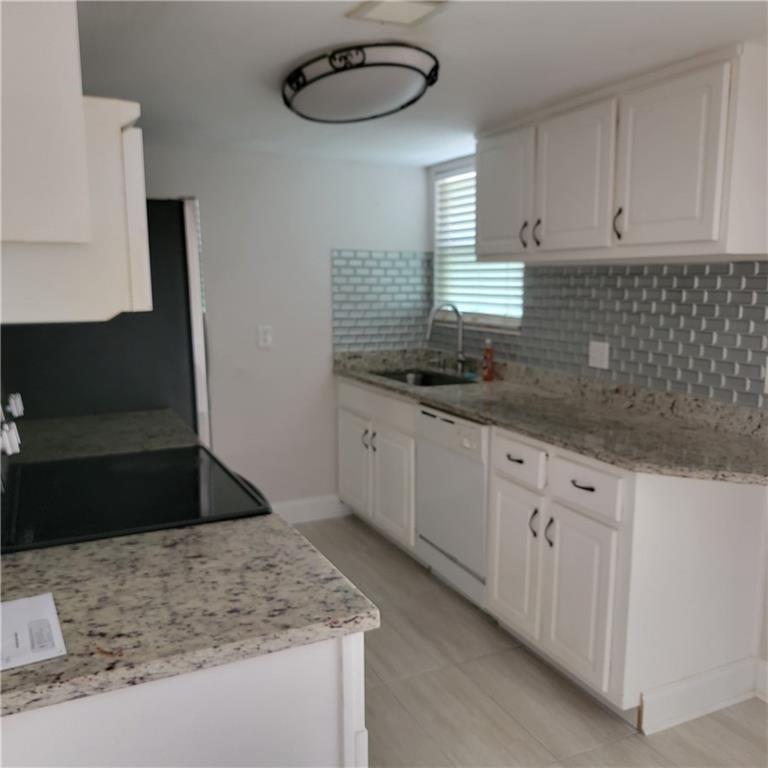 3545 Old Chamblee Tucker Road, Unit C Atlanta, GA 30340 - Photo 5 of 14 a kitchen with stainless steel appliances granite countertop a sink stove and cabinets