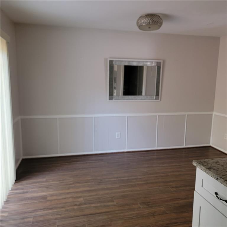 3545 Old Chamblee Tucker Road, Unit C Atlanta, GA 30340 - Photo 8 of 14 a view of an empty room with wooden floor and a window