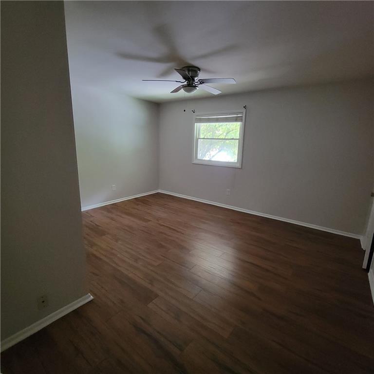 3545 Old Chamblee Tucker Road, Unit C Atlanta, GA 30340 - Photo 10 of 14 an empty room with a window and wooden floor