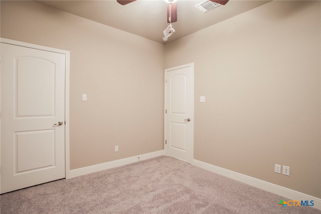 549 Wills Point Way Belton, TX 76513 - Photo 21 of 31 an empty room with a ceiling fan and carpet