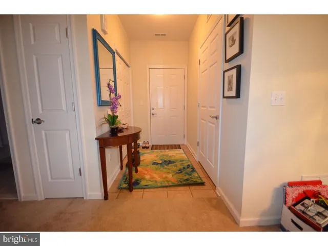 a view of a hallway with wooden floor and entryway