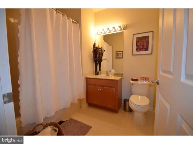 a bathroom with a sink toilet and mirror