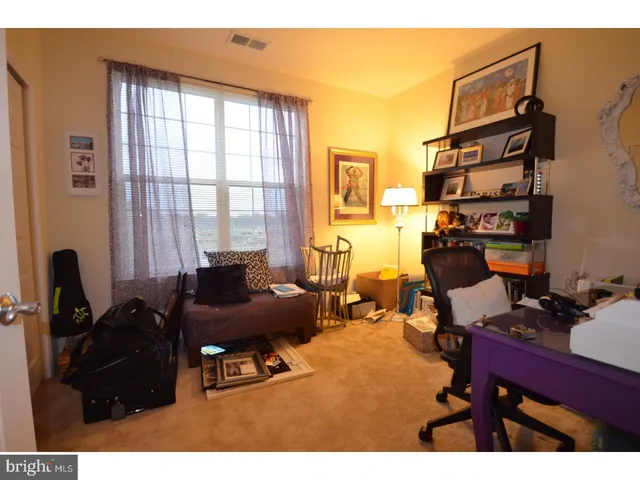 a living room with furniture a flat screen tv and a window