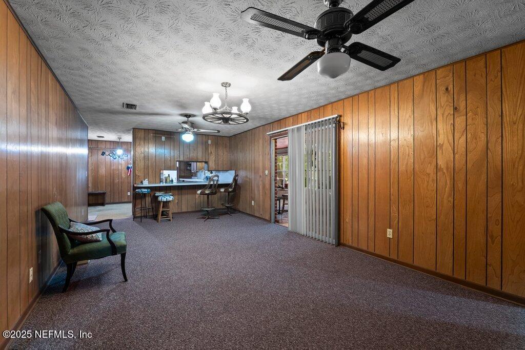 1308 Rigdon Road Jacksonville, FL 32220 - Photo 12 of 32 a view of a livingroom with furniture and chandelier fan