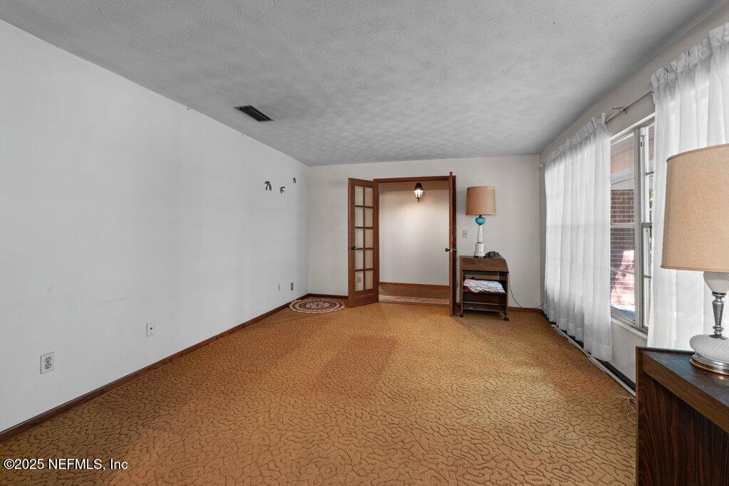1308 Rigdon Road Jacksonville, FL 32220 - Photo 13 of 32 an empty room with windows