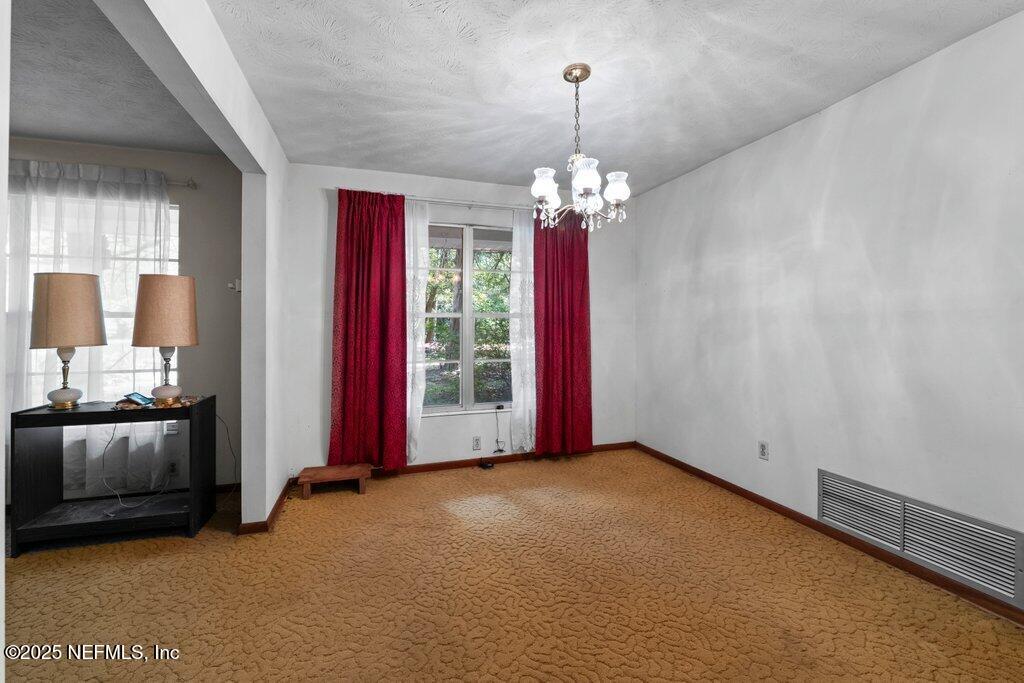 1308 Rigdon Road Jacksonville, FL 32220 - Photo 14 of 32 a view of a livingroom with a chandelier