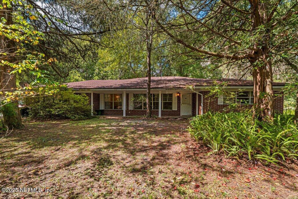 1308 Rigdon Road Jacksonville, FL 32220 - Photo 3 of 32 a front view of a house with a garden