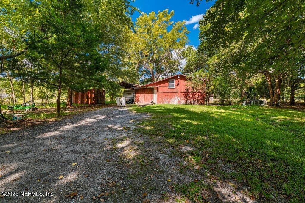 1308 Rigdon Road Jacksonville, FL 32220 - Photo 7 of 32 a backyard of a house with lots of green space