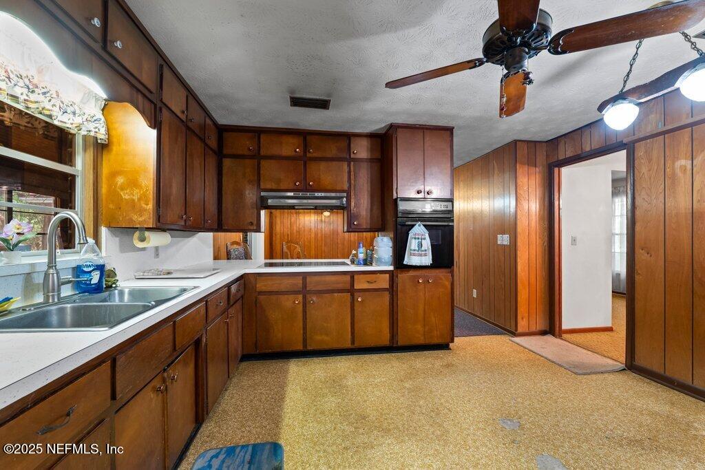 1308 Rigdon Road Jacksonville, FL 32220 - Photo 9 of 32 a large kitchen with stainless steel appliances granite countertop a sink window and cabinets