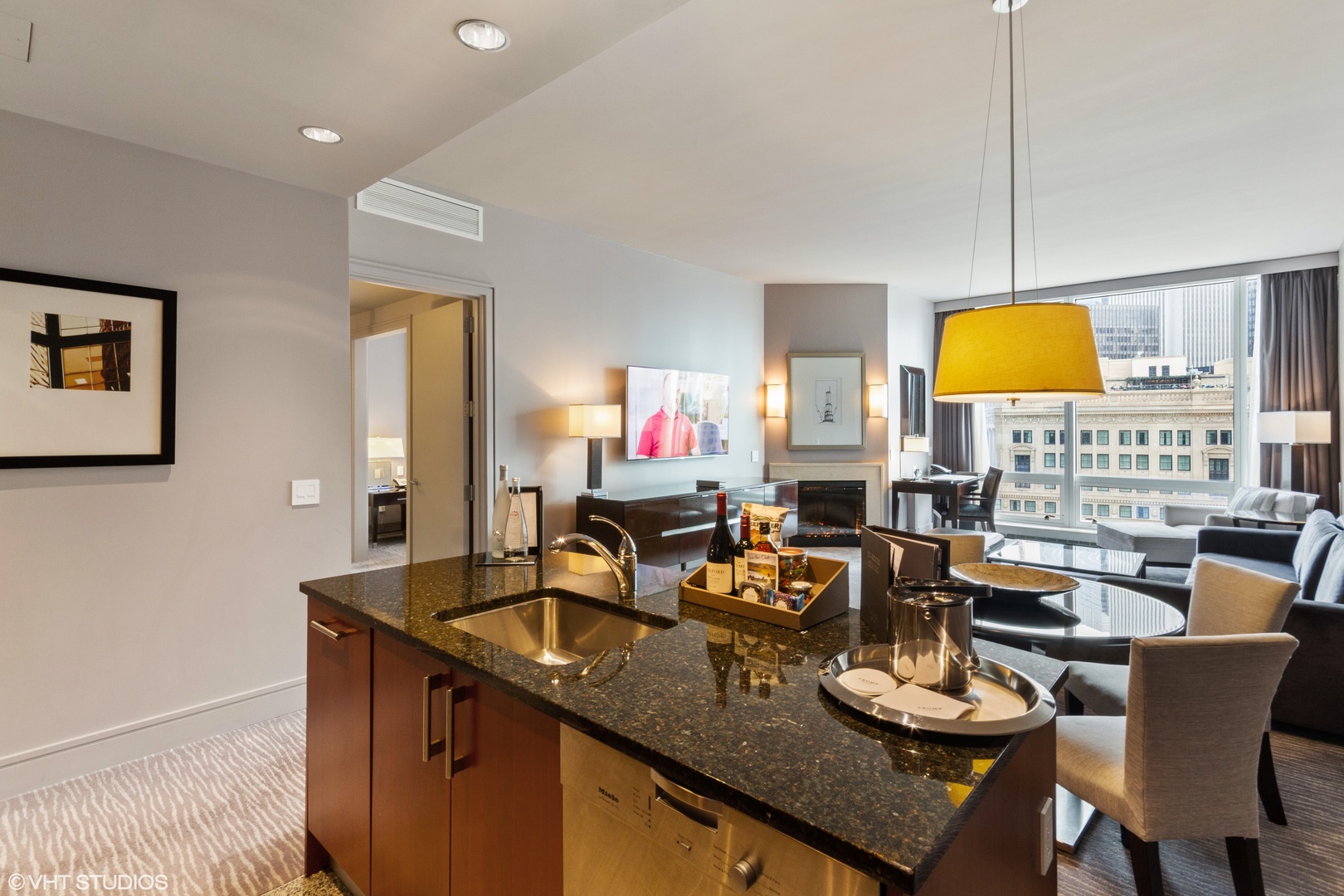 401 North Wabash Avenue, Unit 1842 Chicago, IL 60611 - Photo 4 of 21 a kitchen with a sink dishwasher a dining table and chairs with a dining table