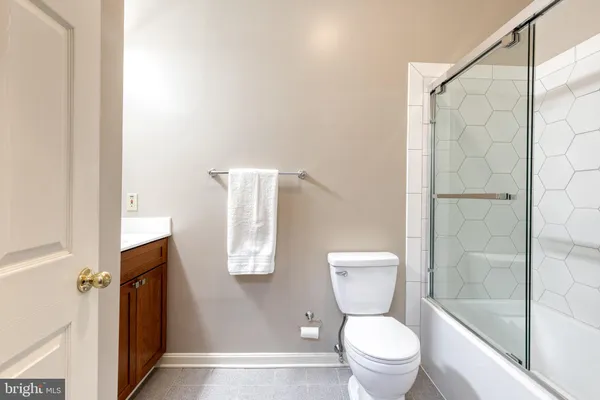 a white toilet sitting next to a bathroom sink