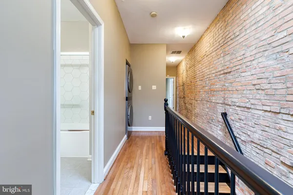 a view of a hallway with washer and dryer