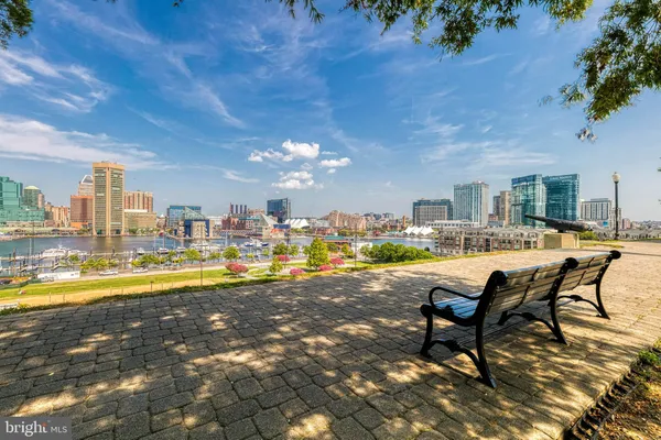 a view of a patio with table and chairs with wooden floor and fence