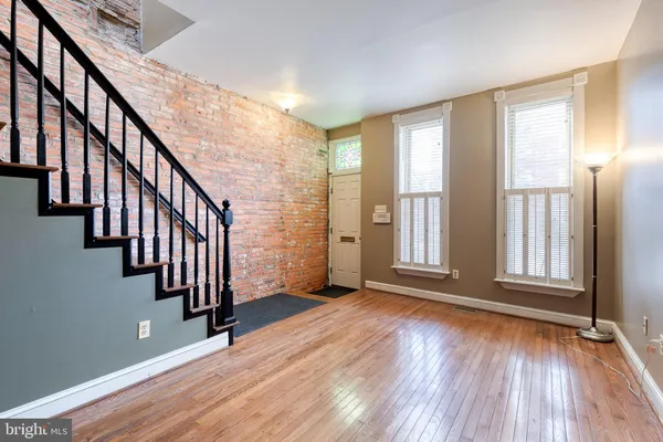 a view of an entryway with wooden floor and door