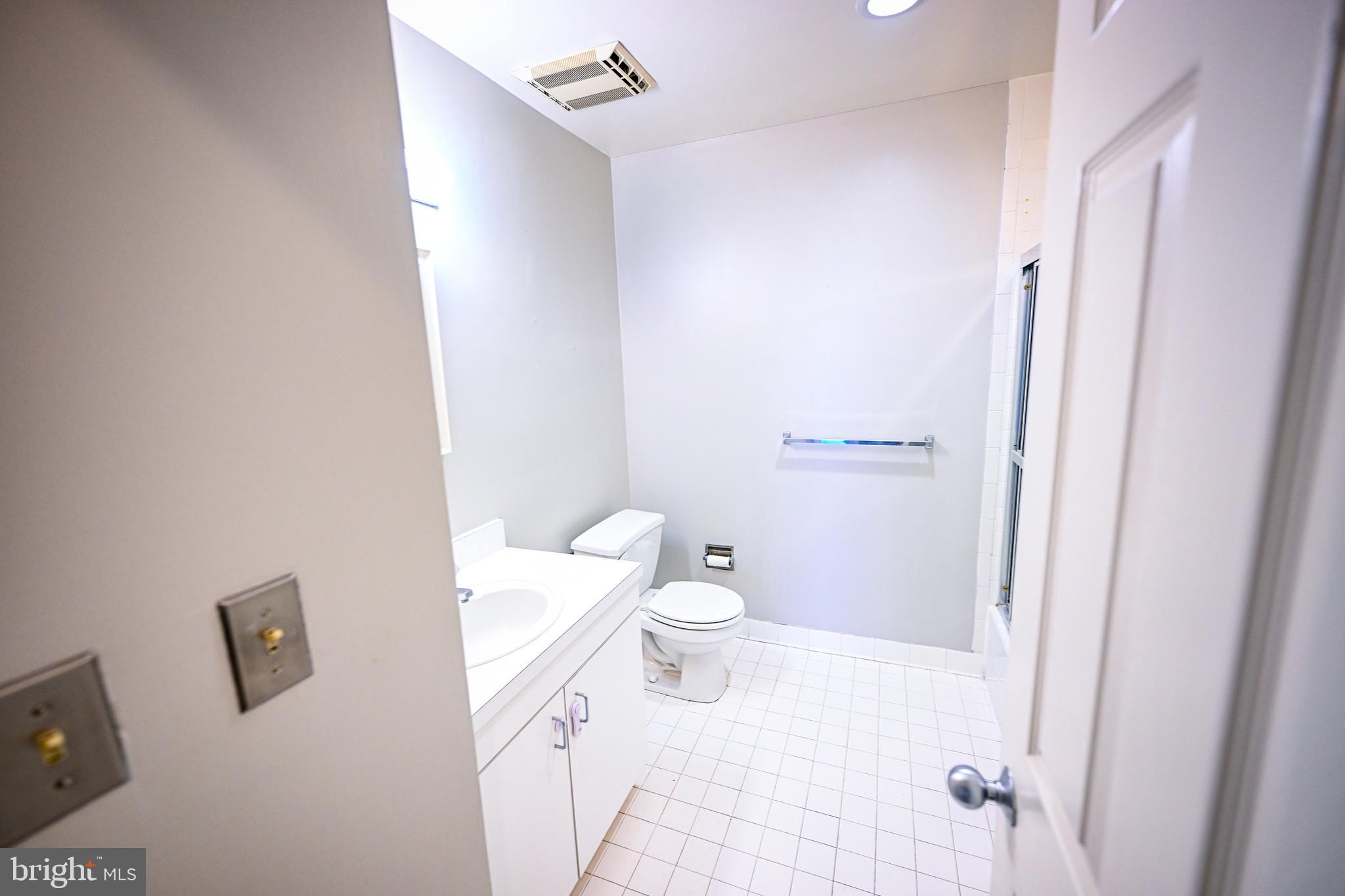 2515 Boston Street, Unit 1108 Baltimore, MD 21224 - Photo 16 of 40 a white toilet sitting next to a bathroom sink