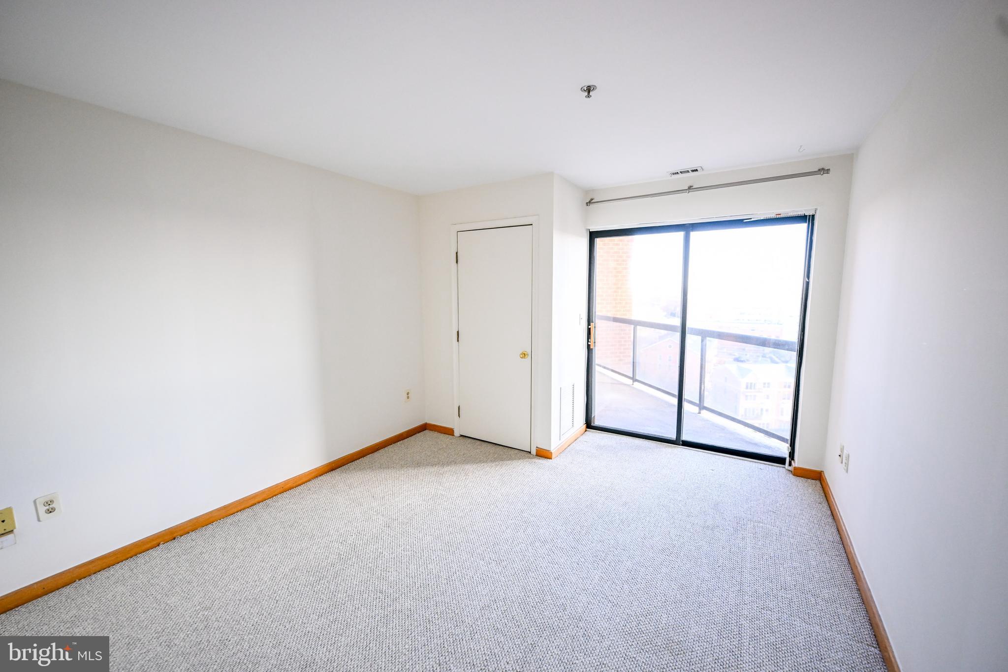 2515 Boston Street, Unit 1108 Baltimore, MD 21224 - Photo 18 of 40 an empty room with windows