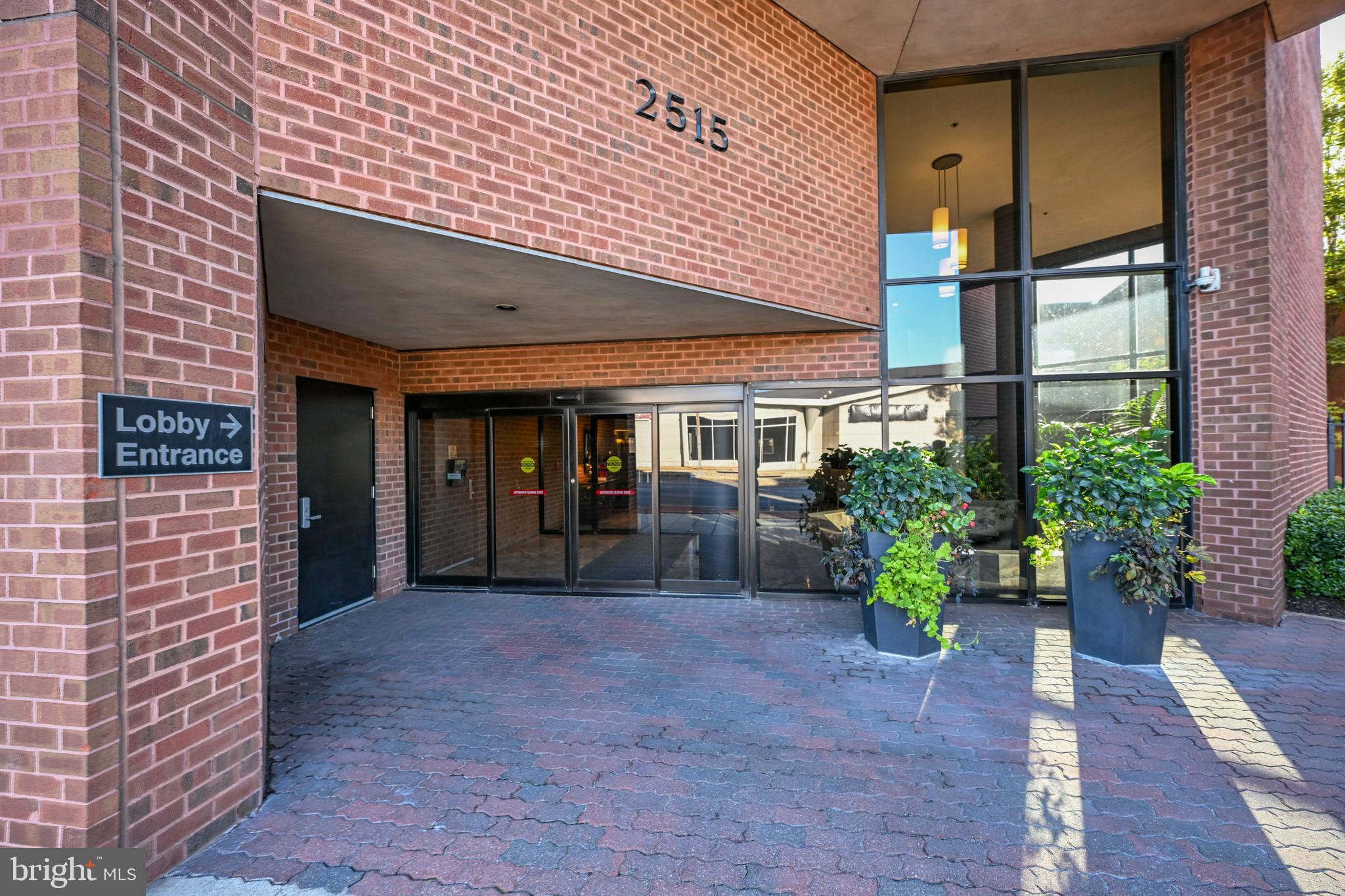2515 Boston Street, Unit 1108 Baltimore, MD 21224 - Photo 29 of 40 a view of a house with large windows and potted plants