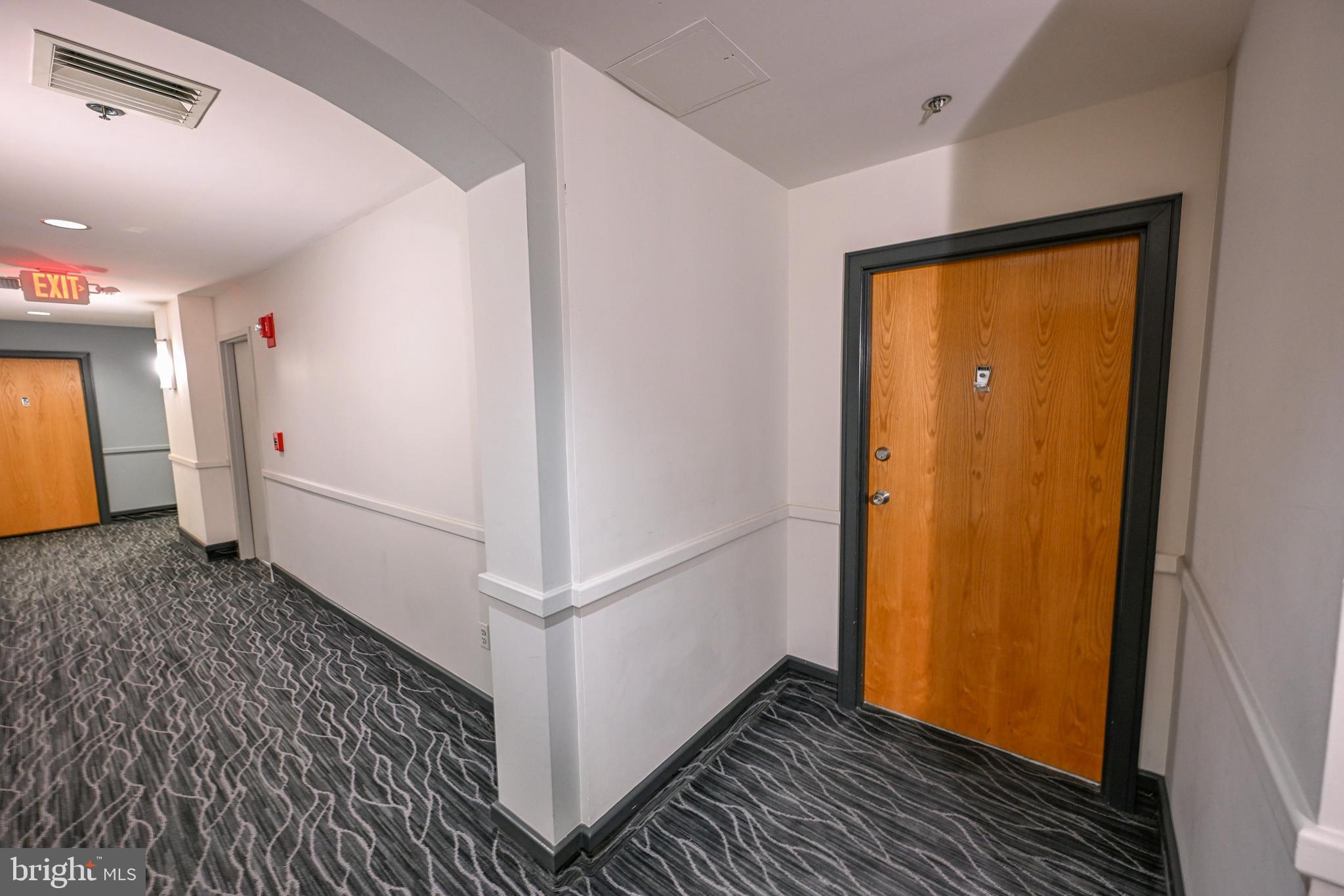 2515 Boston Street, Unit 1108 Baltimore, MD 21224 - Photo 3 of 40 a view of a hallway with wooden floor and entryway