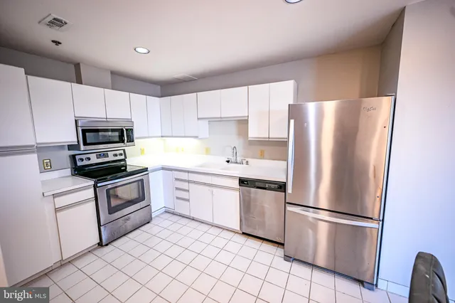 a kitchen with a refrigerator sink and microwave