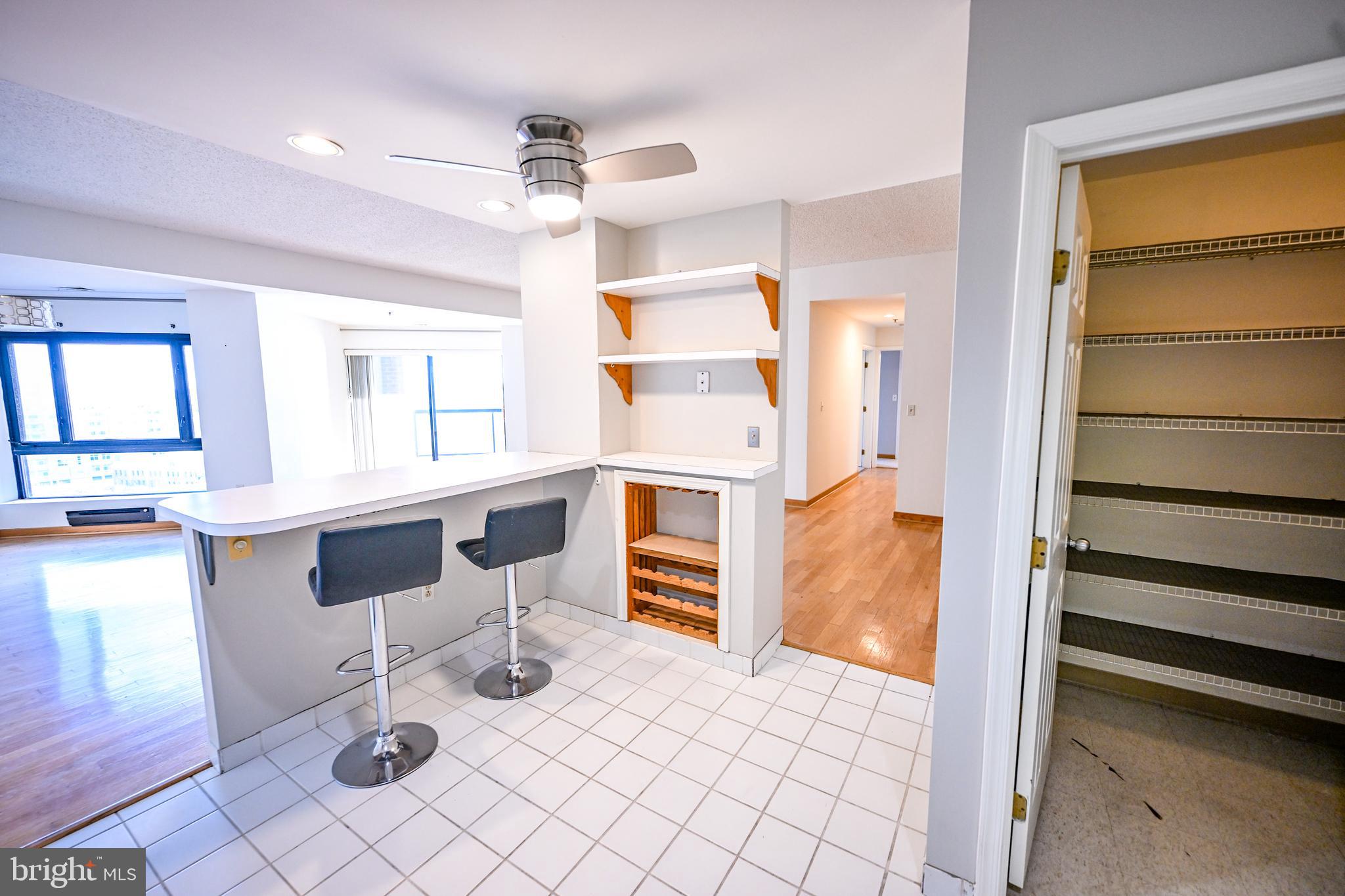 2515 Boston Street, Unit 1108 Baltimore, MD 21224 - Photo 7 of 40 a kitchen with granite countertop cabinets and window