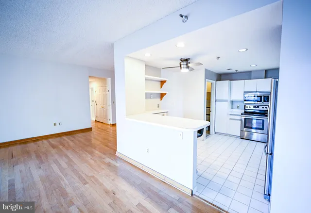 a kitchen with granite countertop a sink and a stove top oven