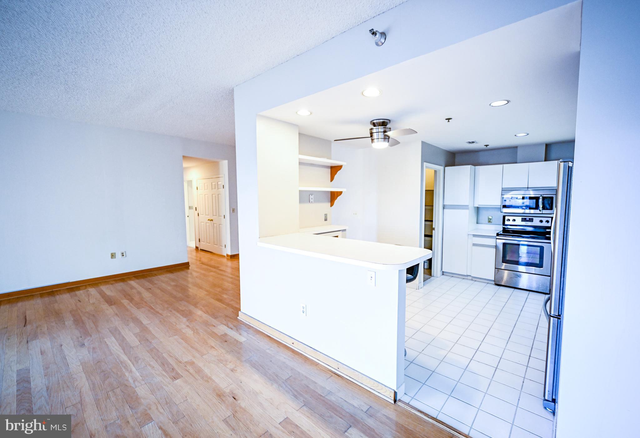 2515 Boston Street, Unit 1108 Baltimore, MD 21224 - Photo 10 of 40 a kitchen with granite countertop a sink and a stove top oven