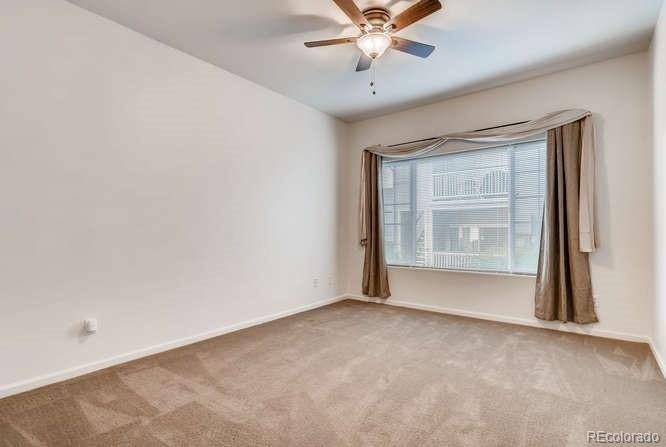 8312 Pebble Creek Way, Unit 104 Highlands Ranch, CO 80126 - Photo 5 of 12 a view of an empty room with a window