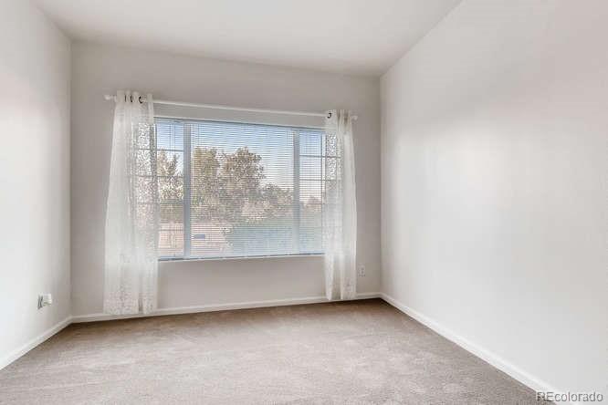8312 Pebble Creek Way, Unit 104 Highlands Ranch, CO 80126 - Photo 7 of 12 an empty room with window