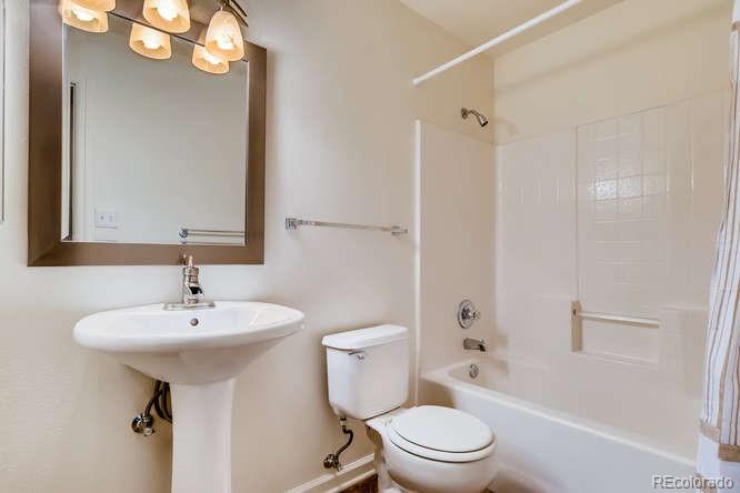 8312 Pebble Creek Way, Unit 104 Highlands Ranch, CO 80126 - Photo 8 of 12 a bathroom with a sink a toilet and shower