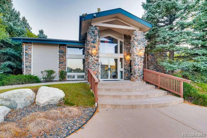 8312 Pebble Creek Way, Unit 104 Highlands Ranch, CO 80126 - Photo 10 of 12 a front view of a house with garden