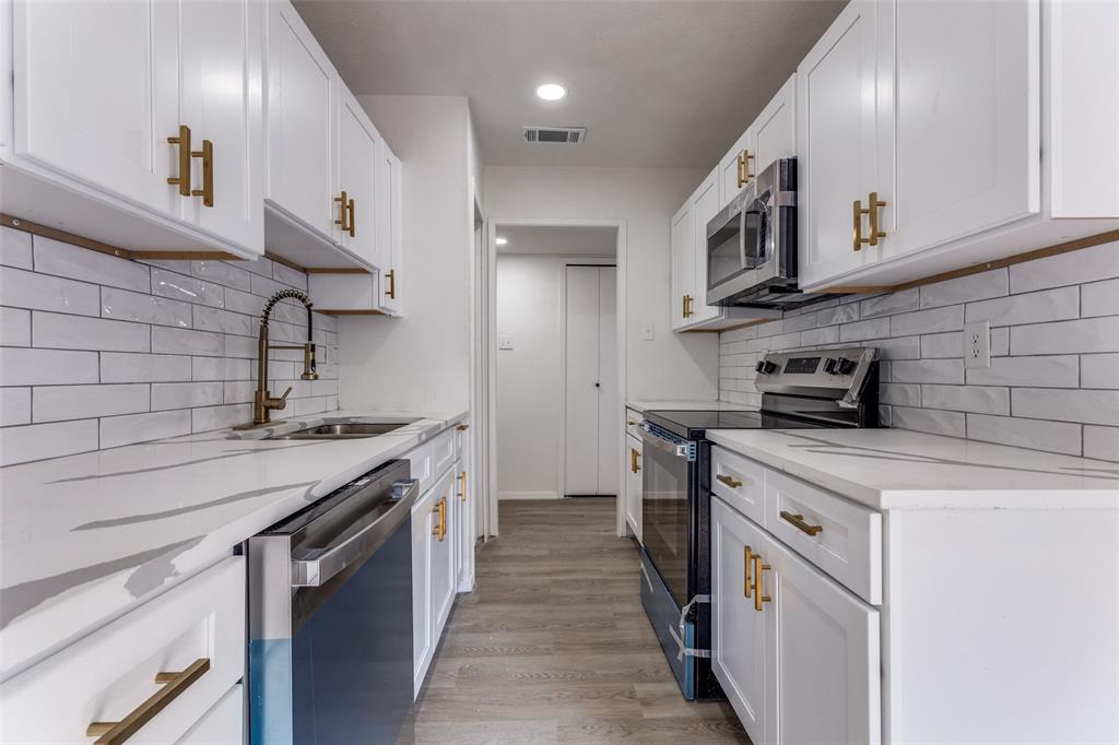 4108 Bristlecone Lane Fort Worth, TX 76137 - Photo 11 of 25 a kitchen with stainless steel appliances granite countertop a sink and a stove