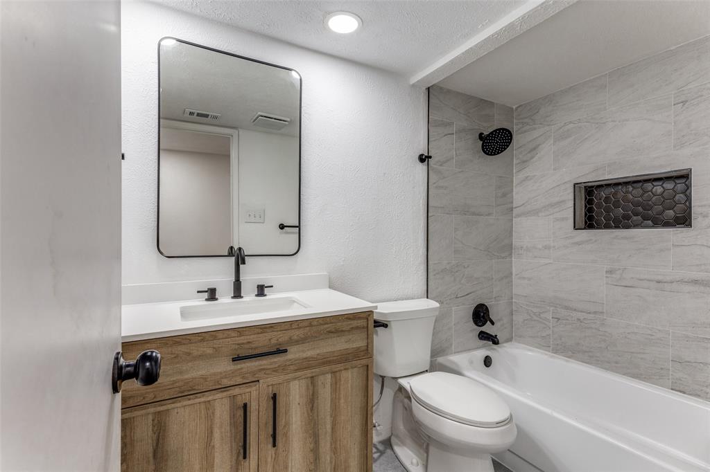 4108 Bristlecone Lane Fort Worth, TX 76137 - Photo 18 of 25 a bathroom with a sink toilet vanity and shower