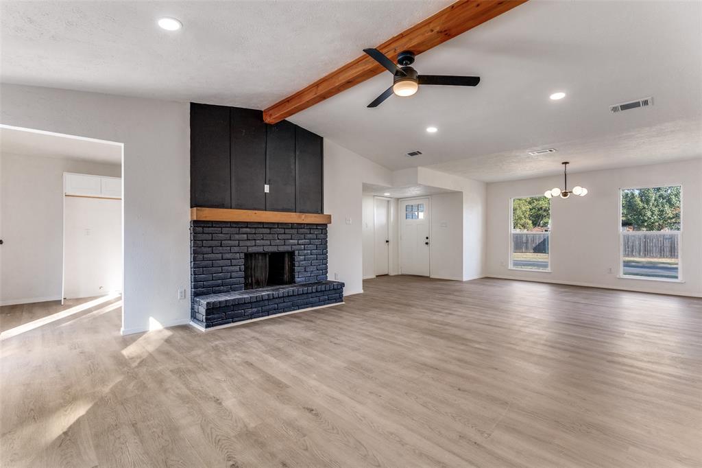 4108 Bristlecone Lane Fort Worth, TX 76137 - Photo 20 of 25 an empty room with windows and fireplace