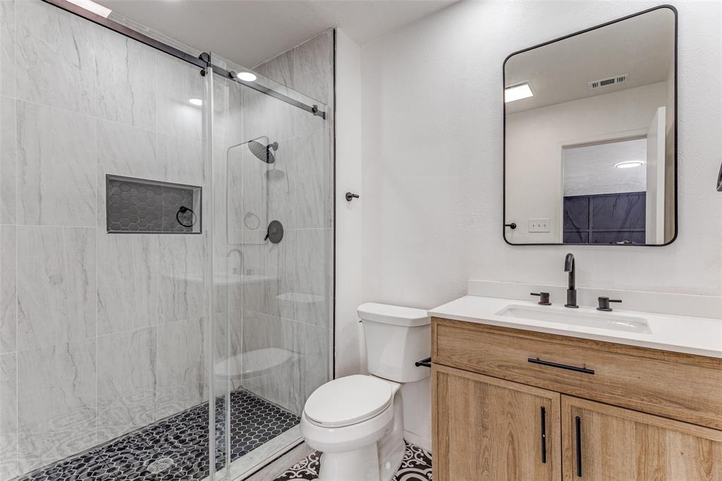 4108 Bristlecone Lane Fort Worth, TX 76137 - Photo 9 of 25 a bathroom with a sink toilet vanity and shower